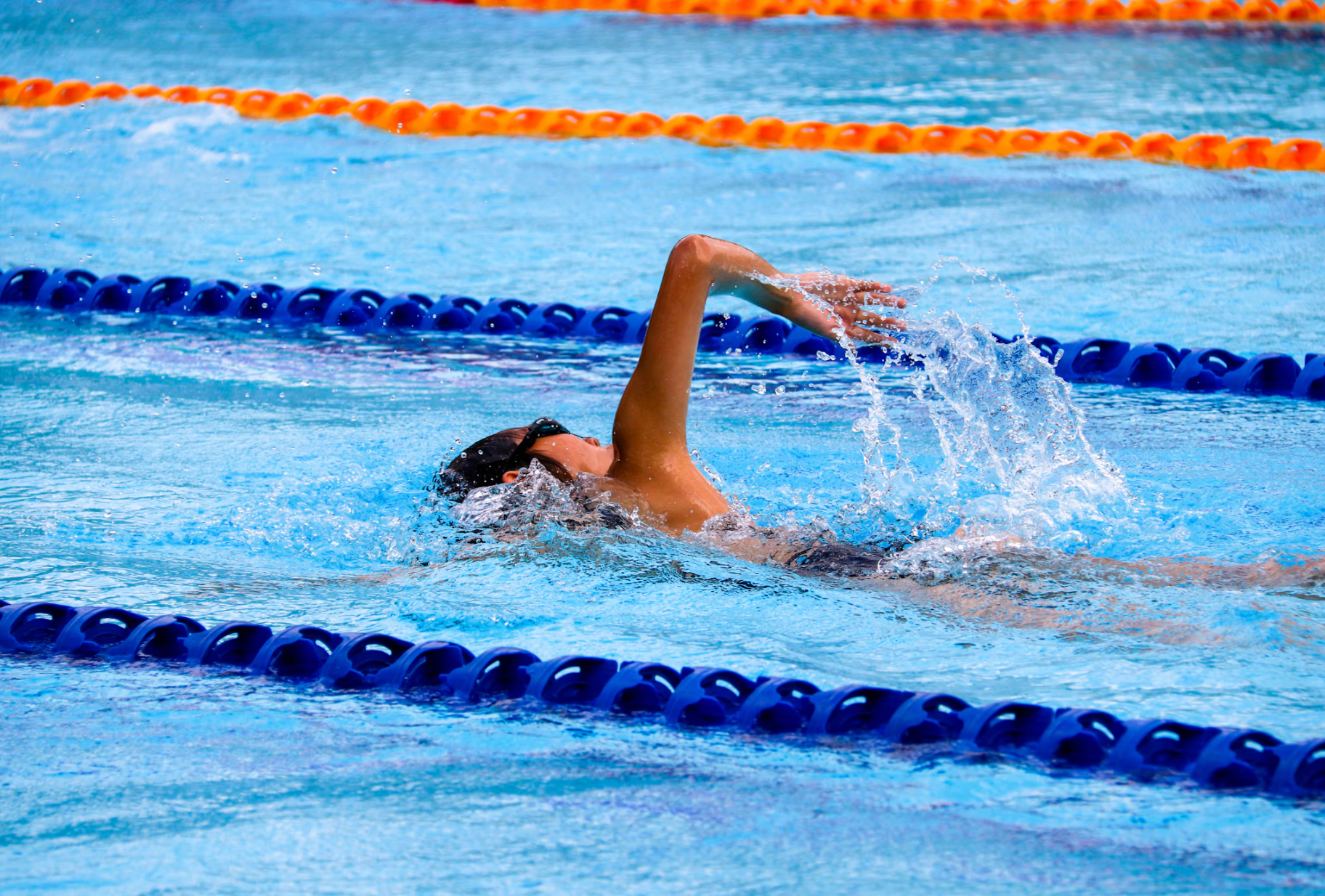 Swimmer mid stroke in a pool