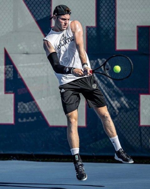 Hunter Robbins playing in an NCAA Division 1 tennis match